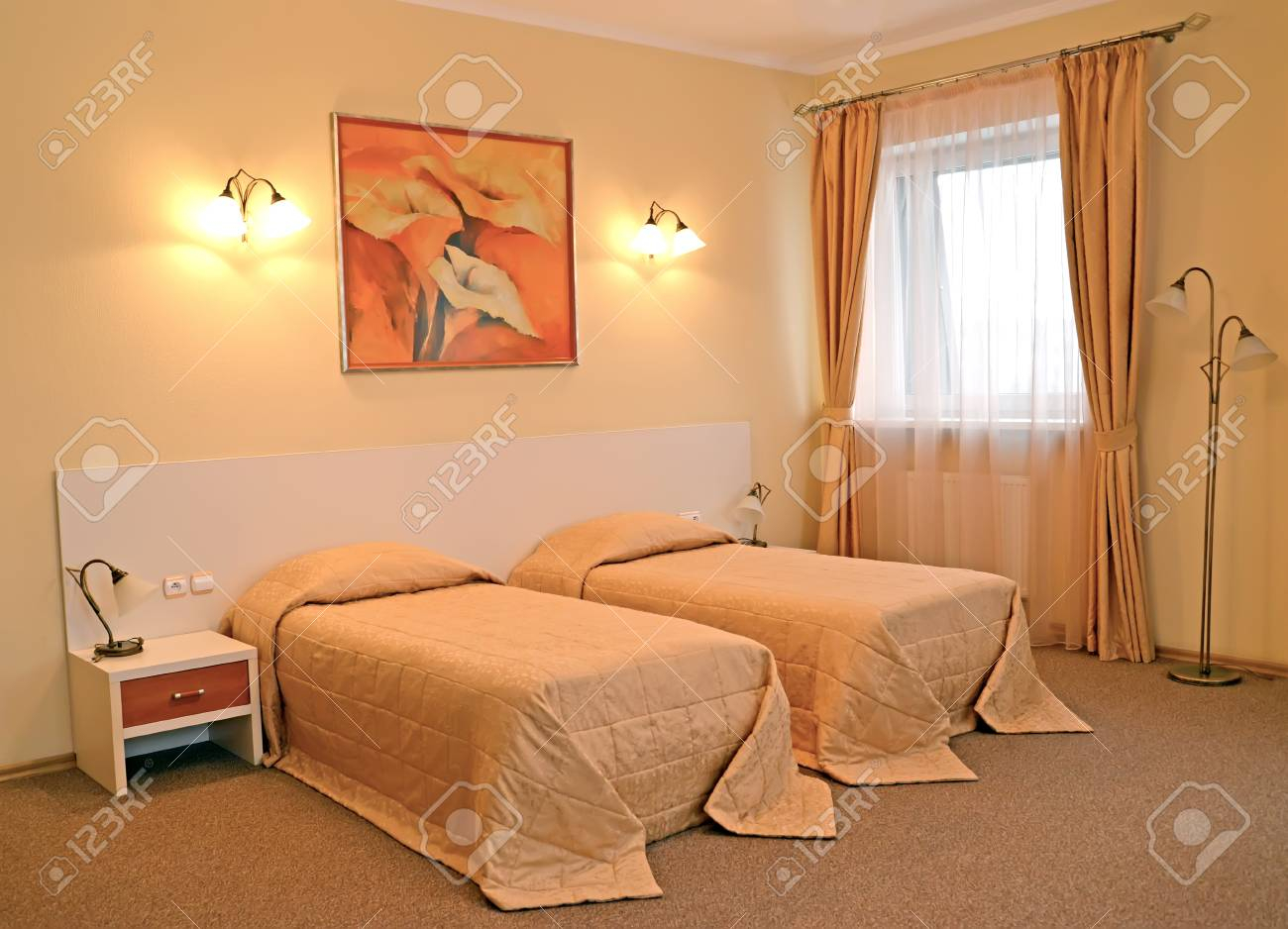 A Bedroom Interior With Two Beds In Warm Colors Stock Photo Picture for sizing 1300 X 938