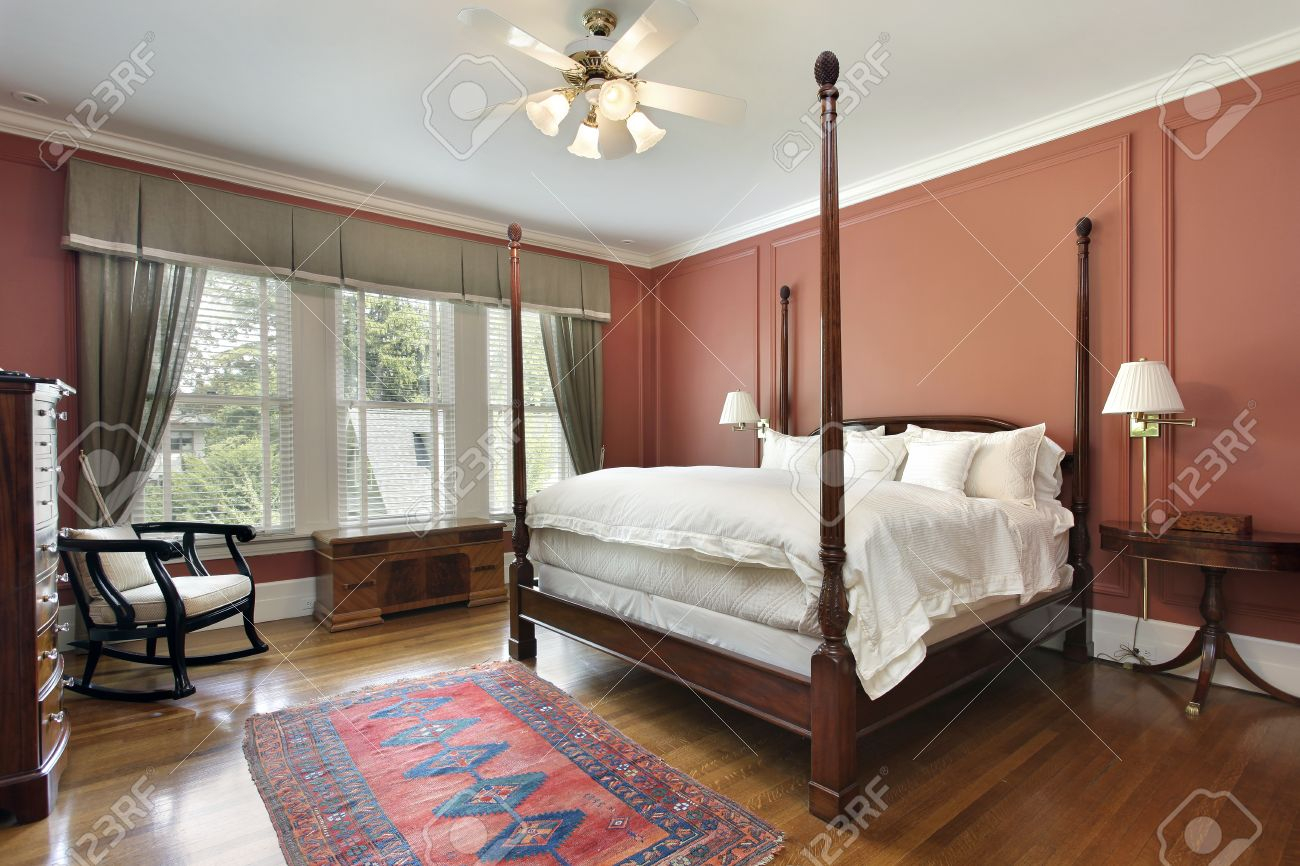 Master Bedroom In Luxury Home With Salmon Colored Walls Stock Photo inside sizing 1300 X 866