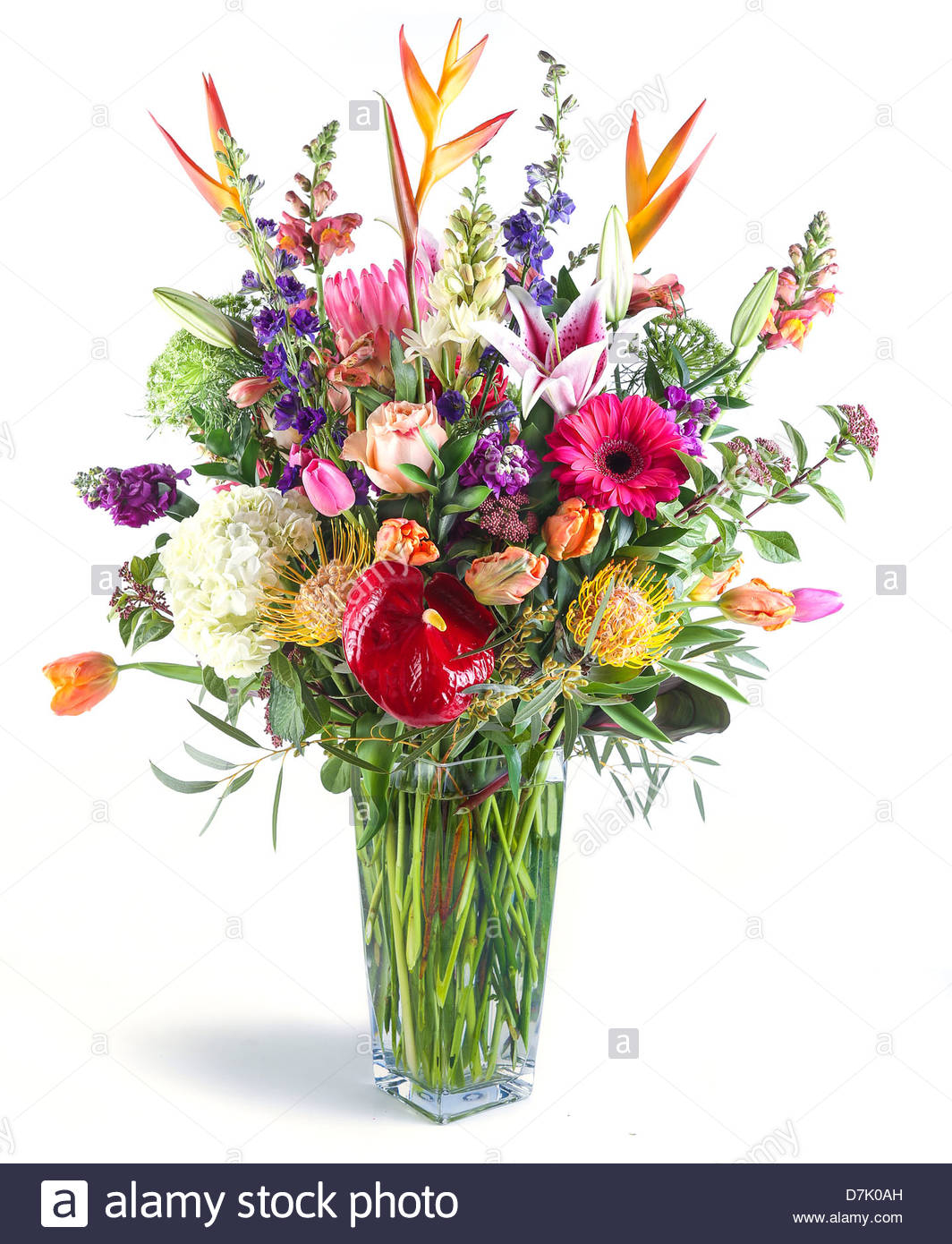 A Large Flower Arrangement In A Tall Clear Glass Vase Stock inside proportions 1064 X 1390