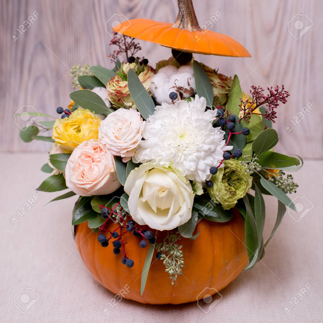 Autumn Floral Bouquet In A Pumpkin Vase On A Light Background A Mixture Of Flowers Pionic Rose Eucalyptus Chrysanthemum Female Hand Holding A inside dimensions 1300 X 1300