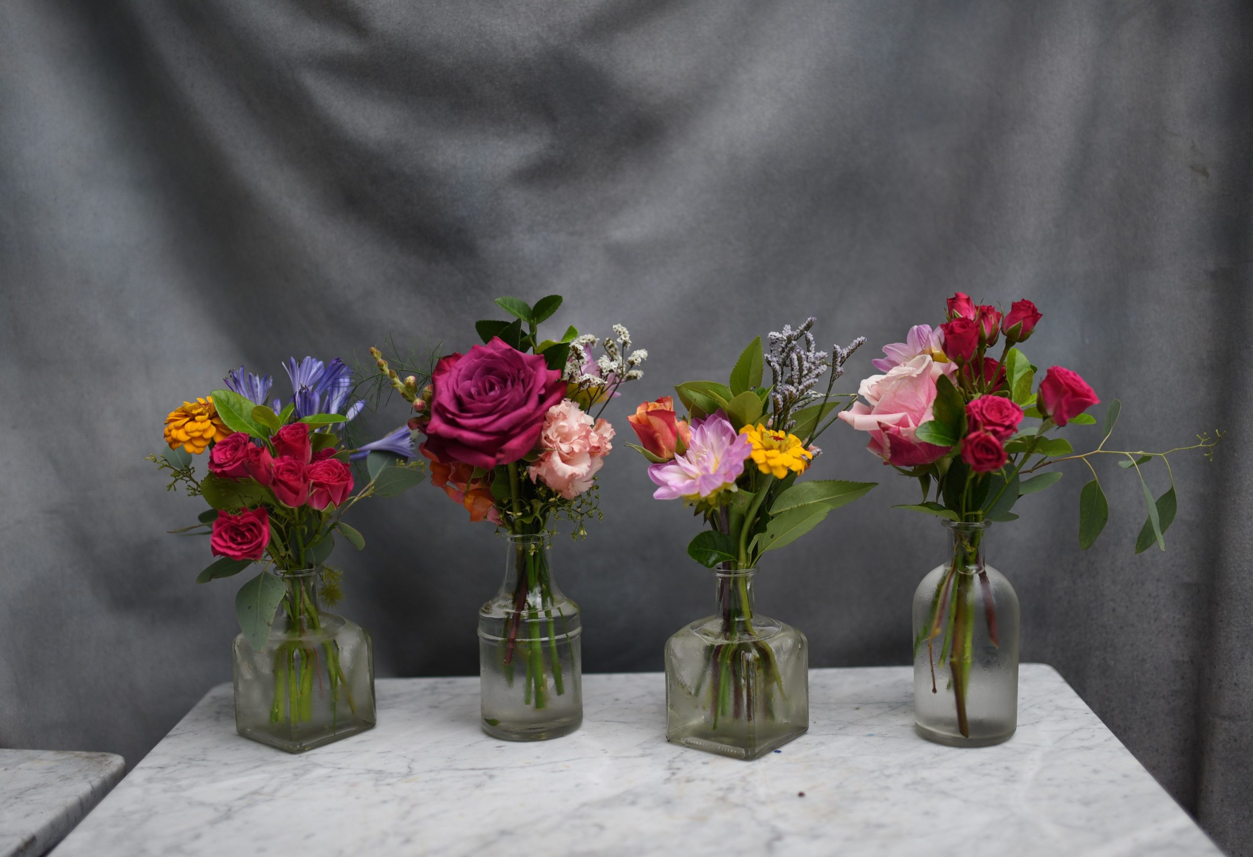 Colorful Mini Bud Vase Arrangement In Small Clear Bottles pertaining to measurements 4948 X 3382