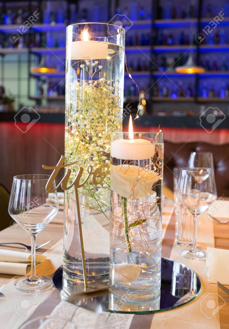 Submerged Flowers And Candle Vase On Reception Table With A Glass regarding proportions 907 X 1300