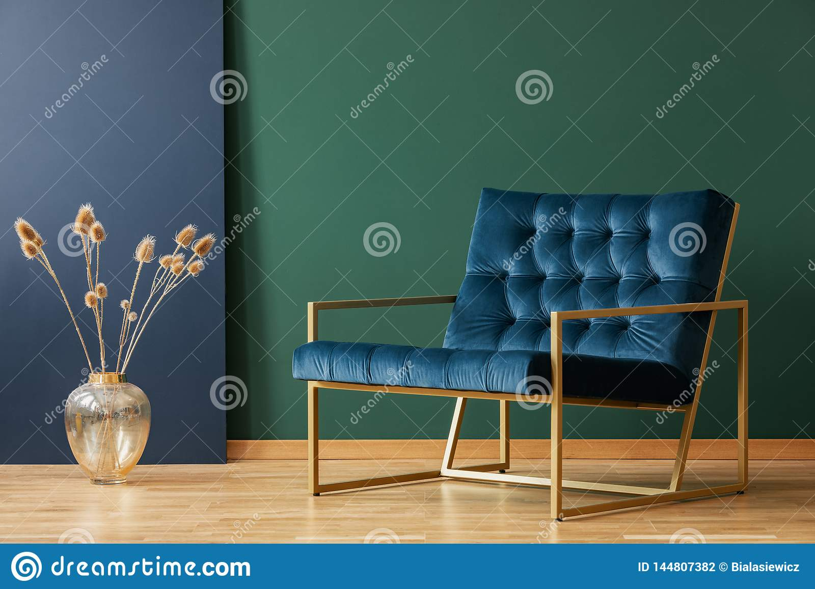 Vase Next To Armchair In Blue And Green Elegant Living Room in proportions 1600 X 1156